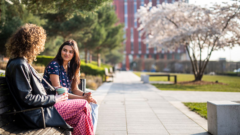 Two women talk at a university