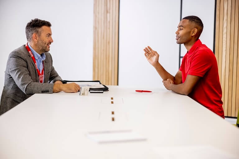 A student taking the IELTS speaking test with an examiner